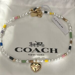 Coach gold, pearl, and multi colored beads choker necklace.